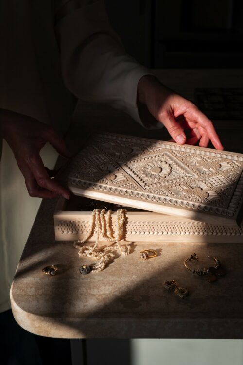 Woman opening wooden jewellery box