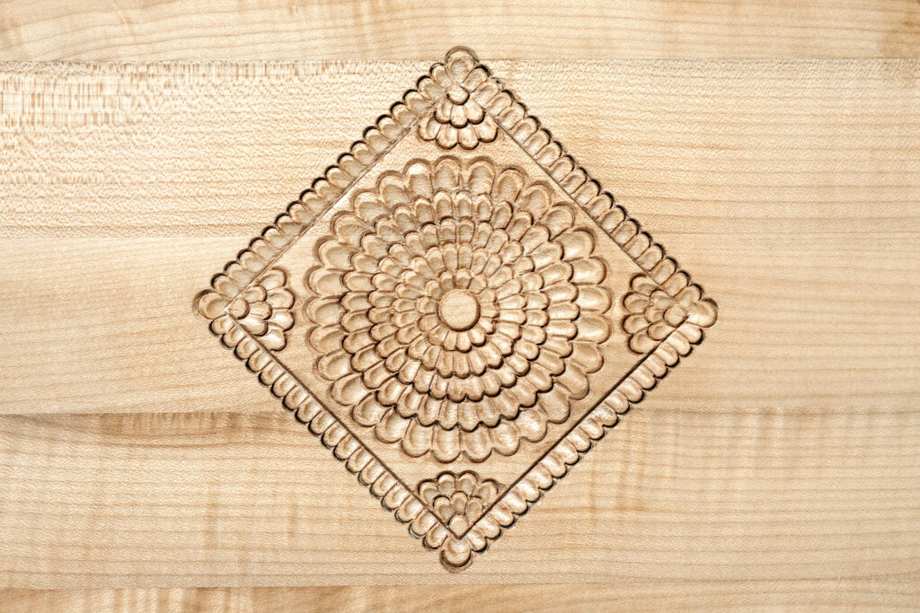 The Konjic rose carved into wood