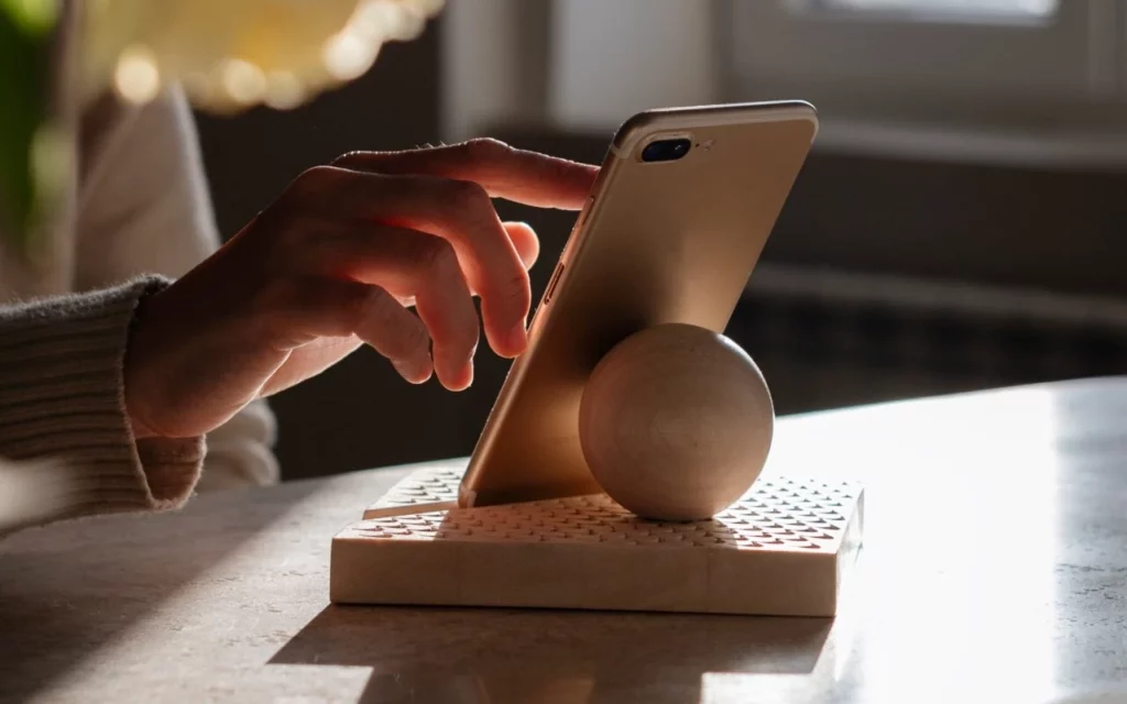 Woman using a wooden phone stand