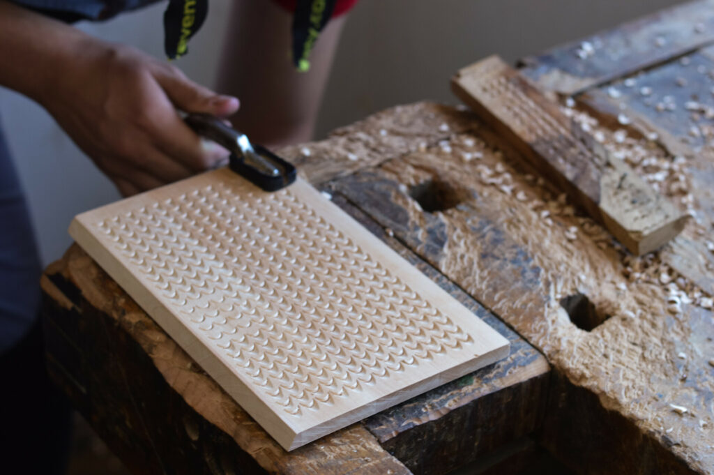 artisan getting ready to carve a wooden tray