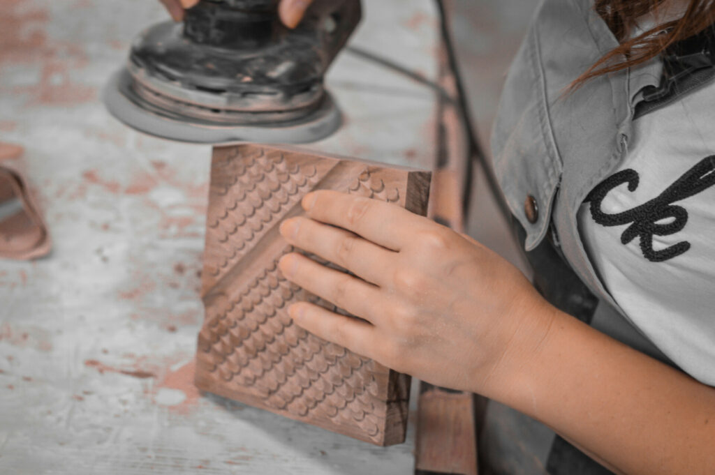 woman sanding the wooden surface