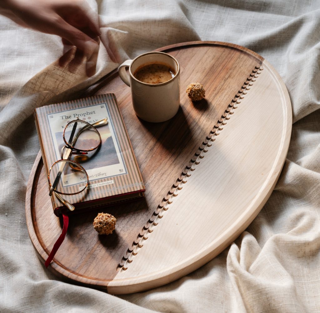 large wooden serving tray with a book on it