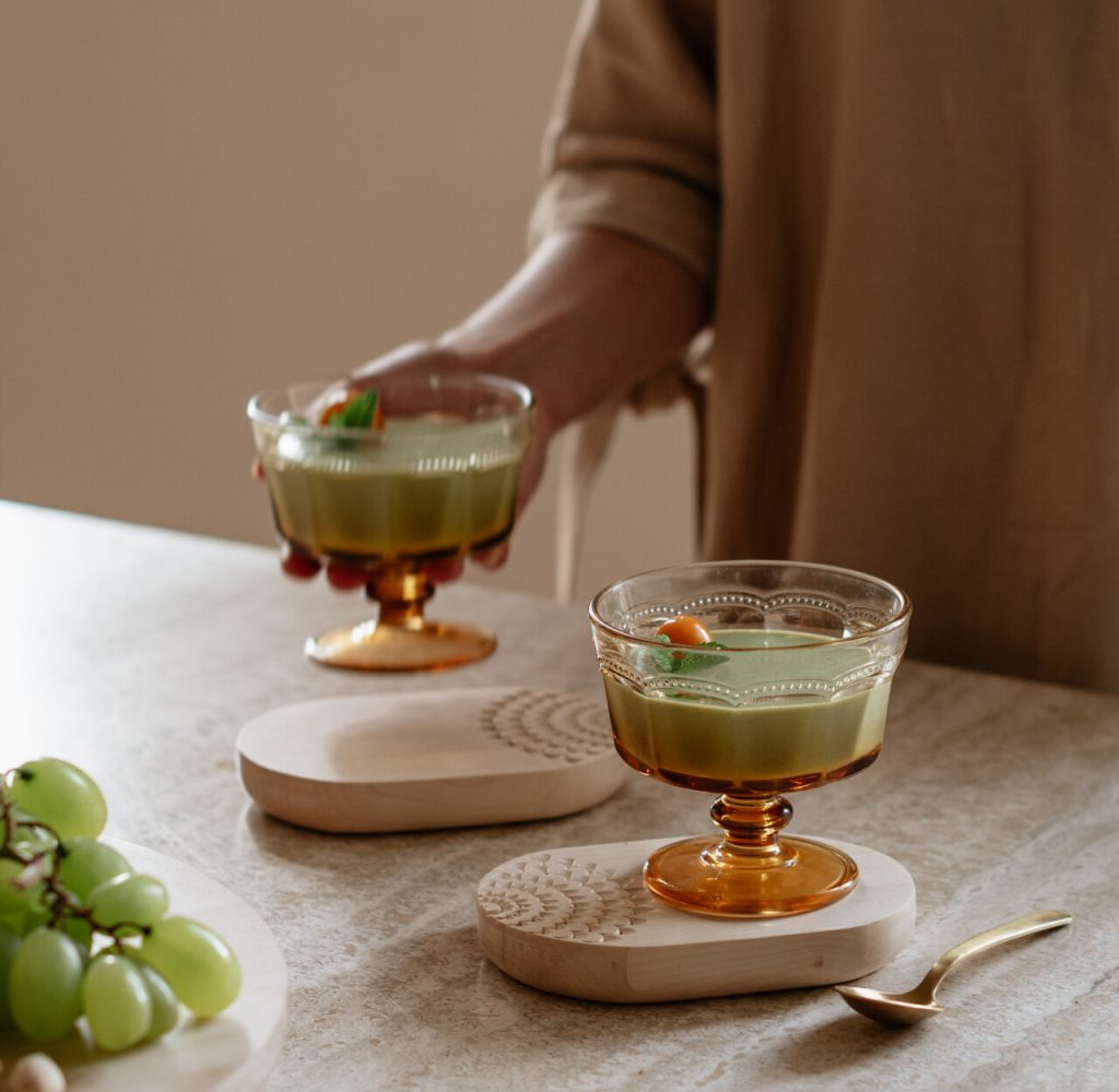 Two desserts on wooden oval coasters